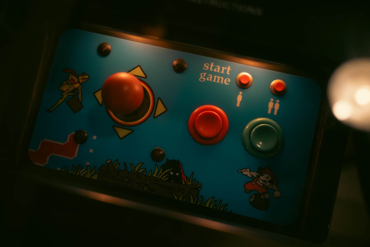 Close-up of retro arcade game controls with joystick and buttons